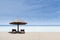 Beach chair and umbrella on white sand