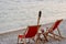 Beach chairs with flambeau at sunset background on Adriatic sea