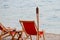 Beach chairs with flambeau at sunset background on Adriatic sea