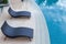 Beach chairs near swimming pool, top view