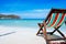 Beach chairs on a sandy beach by the ocean, the concept of relaxation, traveling on a tropical island, relaxation with beautiful