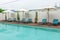 Beach chairs and swimming pool in the resort holiday.