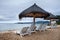 Beach chairs and thatched umbrellas