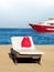 Beach chaise and a boat at sea