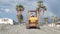 Beach cleaning. A motor grader levels the sand on a Tyrrhenian Sea beach in Calabria.