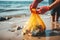 Beach cleanup concept: Human hands collect waste to save nature