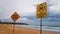 Beach Closed Sign and Dangerous Current Sign On Beach