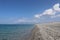 Beach on the coast of Calabria, Italy on a sunny summer day. Bright blue sea and white pebbles on a sunny summer day