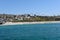 The beach and coastline with surfers and sunbathers seen from the pier in the South Orange