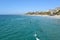 : The beach and coastline with surfers and sunbathers seen from the pier in the South Orange
