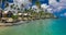 Beach with with coconut palm trees and villas on Samoa Island