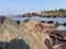 Beach with the coconut trees with the rocky sea shore