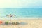 The beach color blue water and umbrella. the chair is on the sand