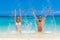 Beach couple looking. Happy young couple lying on sand under sun