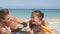 Beach couple putting sunscreen suntan face lotion