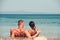 Beach couple on romantic travel honeymoon vacation summer holidays romance. Young happy lovers, woman and Caucasian man
