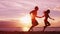 Beach couple running having fun holding hands on beach enjoying romantic sunset