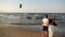 Beach couple walking on romantic travel honeymoon vacation summer holidays romance. Back rear view of casual young happy