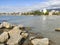 Beach with crystal clear water of the Mediterranean Sea next to a stone walkway and the city of BenicÃ¡sim-BenicÃ ssim, in Castell