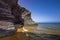 Beach with crystalline and transparent waters of bluish and greenish colors with golden sand and gray and purple rocks