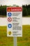 A beach danger sign with rules in both english and french