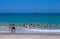 Beach day in summer with sun and sand with bathers on vacation at the edge of the beach