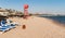 Beach day with umbrellas, deckchairs and rescue tower