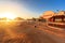 Beach with deck chairs, parasol, and bar during sunrise