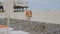 On the beach, deserted in bad weather, there is a lifebuoy on the counter.