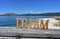 Beach with Dream wooden sign. Galicia, Spain, sunny day.