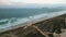 Beach with dunes and ocean with sunset lights in Campeche, Florianopolis