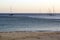 Beach at dusk with Sailboats in the sea