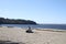 A beach on the edge of a bay looking across the water