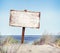 Beach with Empty Plank Sign