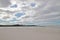 Beach expanse with cloudy skies