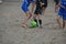 Beach football - blue and black teams playing in a match