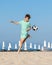 Beach football. Child boy play with soccer ball while having fun on sandy beach. Kids active games, summer holidays
