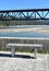 Beach with forest, promenade with stone bench and train bridge over Sor coastal river. O Barqueiro, CoruÃ±a, Galicia, Spain.