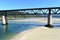 Beach with forest and train bridge over Sor coastal river. O Barqueiro, A Coruna Province, Galicia, Spain.