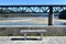 Beach with forest and train bridge over Sor coastal river. Promenade with stone bench. O Barqueiro, A Coruna Province, Spain.