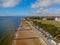 Beach frinton on sea essex groins seaside water ocean blue clouds beach huts grass view waves steps trees