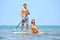 Beach fun couple on stand up paddleboard