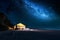 Beach with glowing tent at night with stars