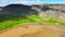 Beach with golden sand and green grass on the ocean in Iceland. An unusual and fascinating landscape of the northern