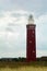 Beach grass with lighthouse Westhoofd in Ouddorp in the Netherlands in landscape