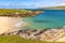 Beach with grass, rocks and sand