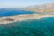 The beach by the greenhouses and olive trees in the countryside , in Europe, in Greece, in Crete, towards Kissamos, towards Chania