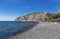 Beach with grey volcanic sand at Kamari, Santorini island