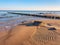 Beach with  Groynes and Sand Ripples under clear blue sky, no traces of man