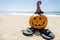 Beach Halloween background with pumpkin in the witch`s hats